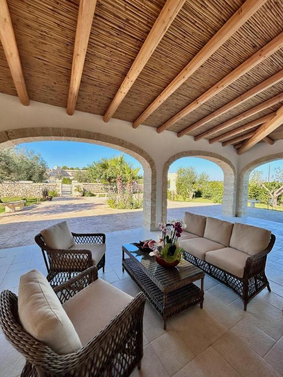 Shaded terrace with lounge seating under wooden beams